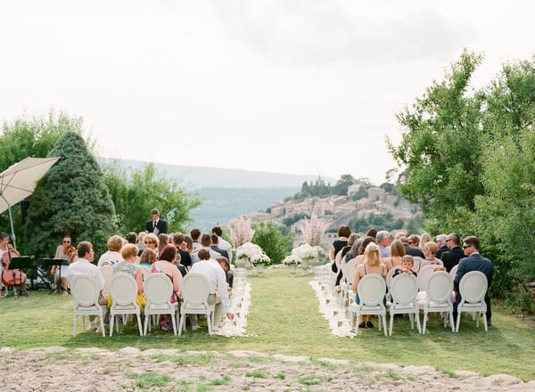 Wedding guests sitting for outdoor ceremony in Bonnieux in Provence