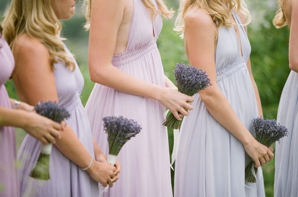 Bridesmaids holding lavender bouquets