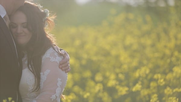 Groom hugging bride