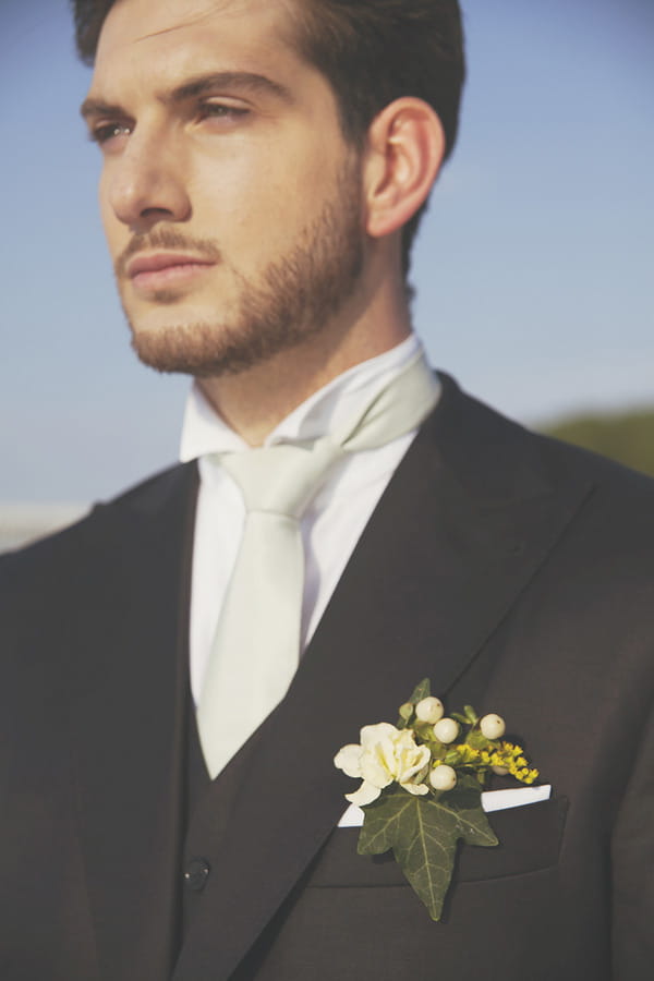 Groom with white cravat and yellow buttonhole