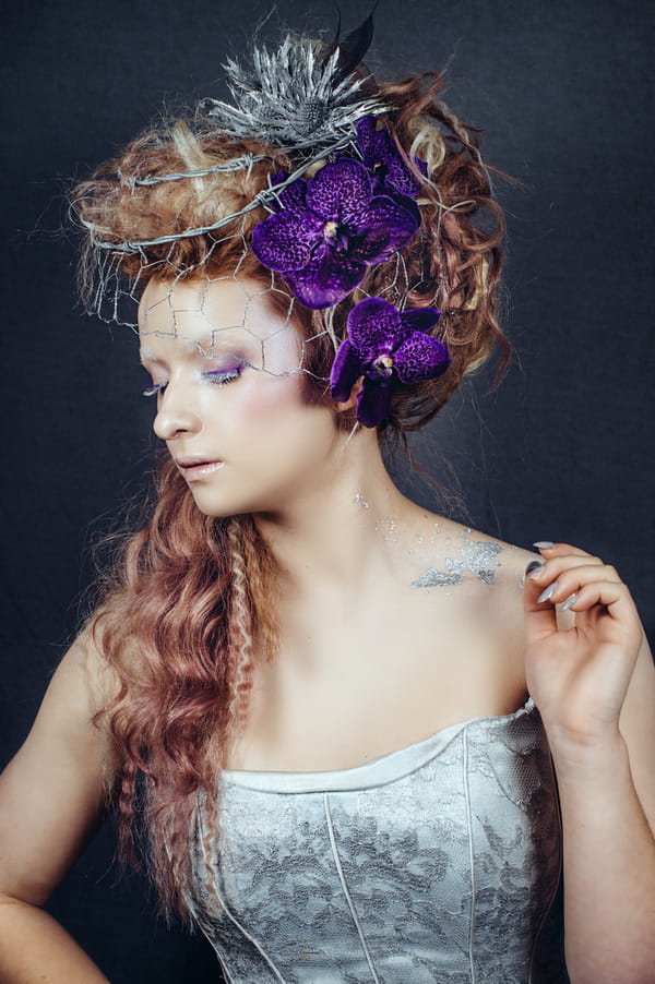 Bride with purple orchids in hair and chicken mesh veil