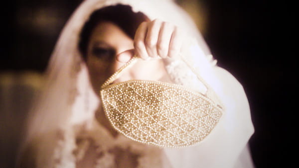 Bride holding vintage beaded clutch bag