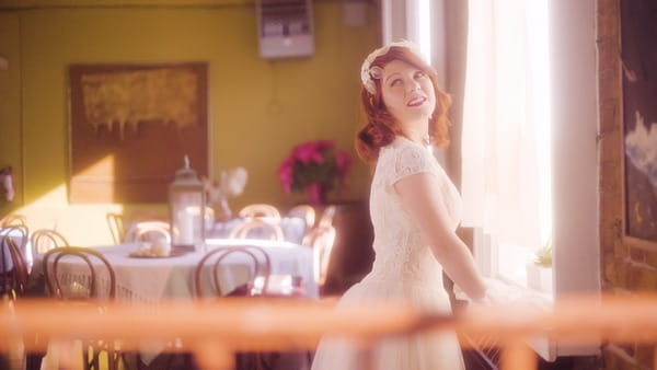 Vintage bride standing by window