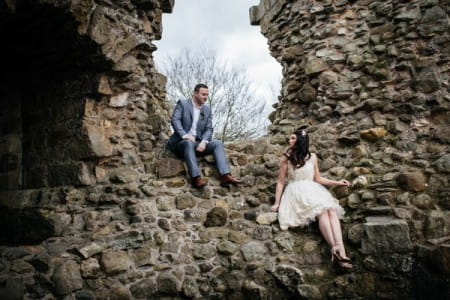 Bride and groom sitting on wall - Picture by Jess Yarwood Photography