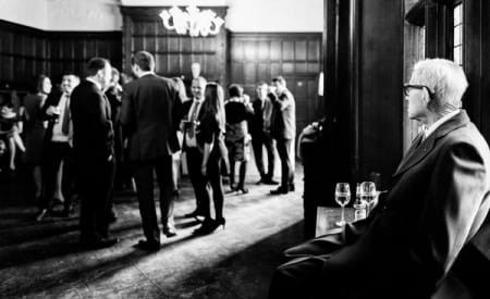 Elderly man sitting watching guests at wedding drinks reception - Picture by Joan Jellett