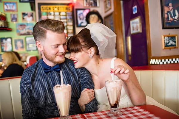 Retro bride and groom drinking milkshake in American diner - Picture by Binky Nixon Photography