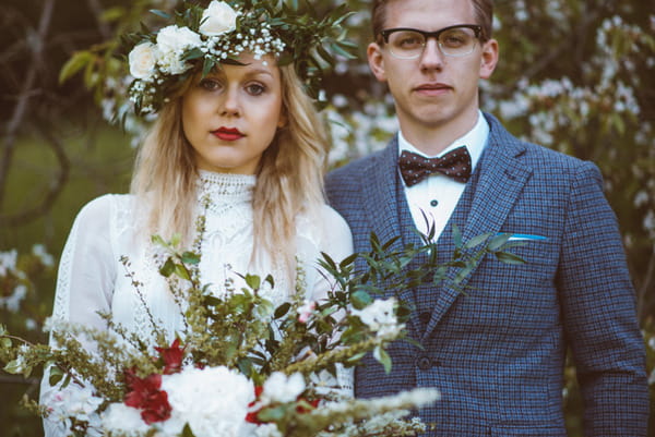 Vintage bride with flower crown standing with groom