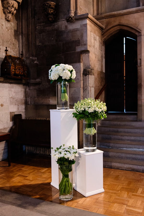 Vases of flowers in church for wedding ceremony