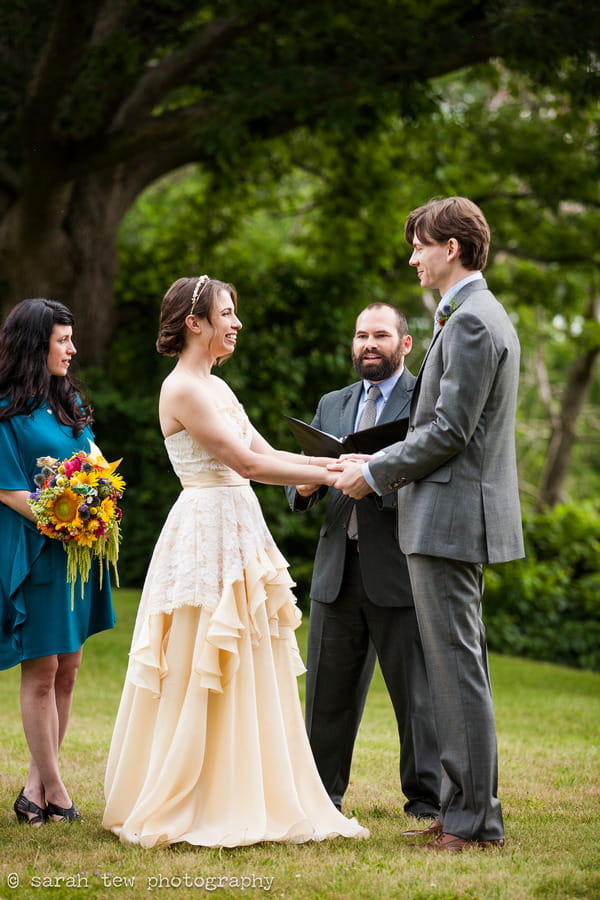 Bride and groom holding hands during wedding ceremony