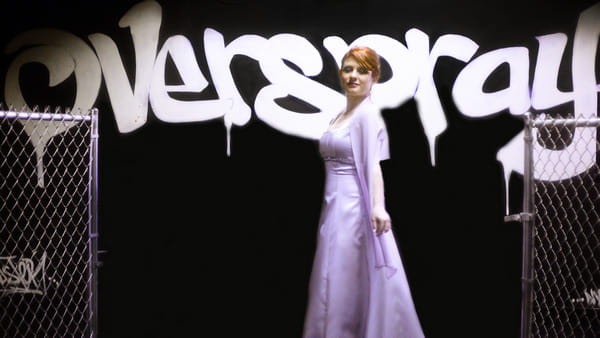 Bride standing next to wall with graffiti