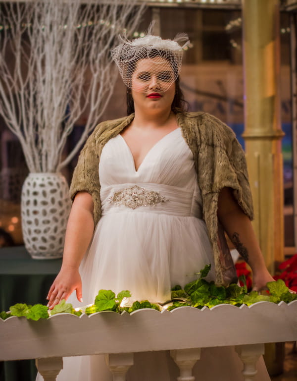 Bride wearing wedding dress and fur shrug