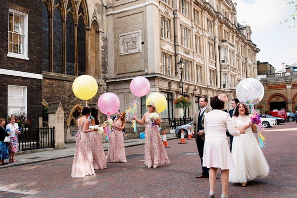 Bridesmaids with pink and yellow balloons