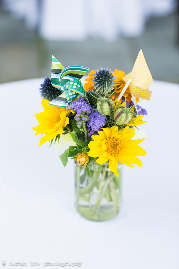 Bright flowers and pinwheels in vase