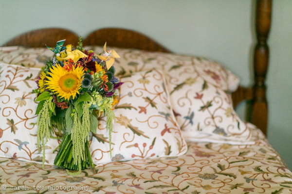 Bright wedding bouquet on bed