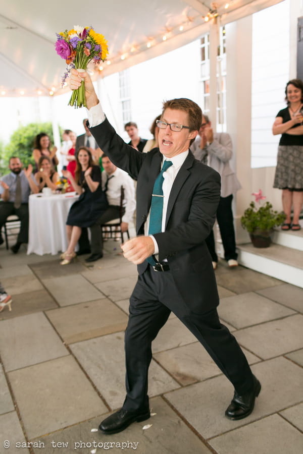 Man catching bride's bouquet