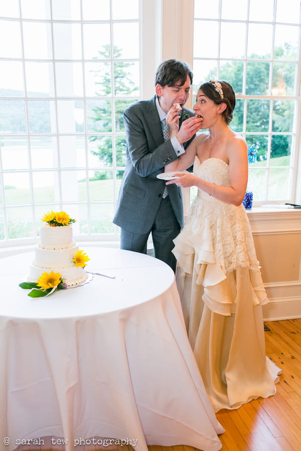 Bride and groom eating wedding cake