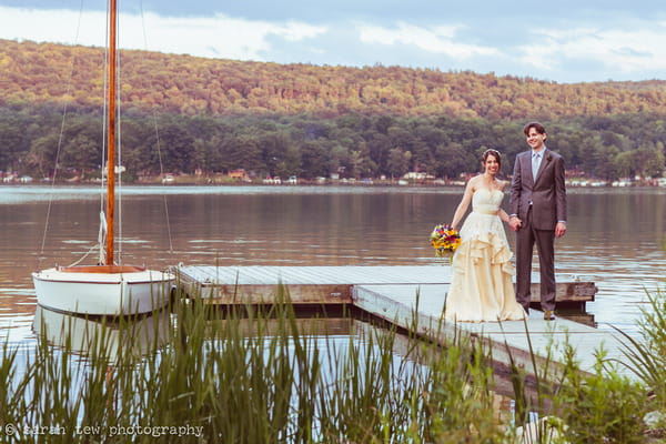 Bride and groom holding hands by Finger Lakes