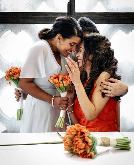 Bride and bridesmaids hugging and smiling - Picture by RR Photographic