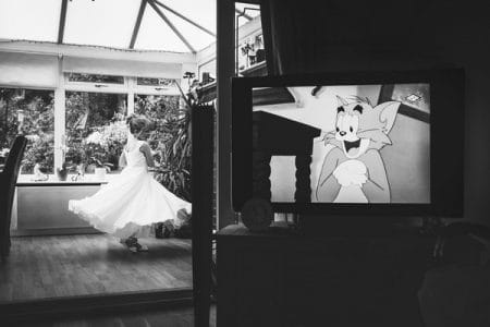 Cartoon character on television appearing to watch flower girl dancing - Picture by French Connection Photography