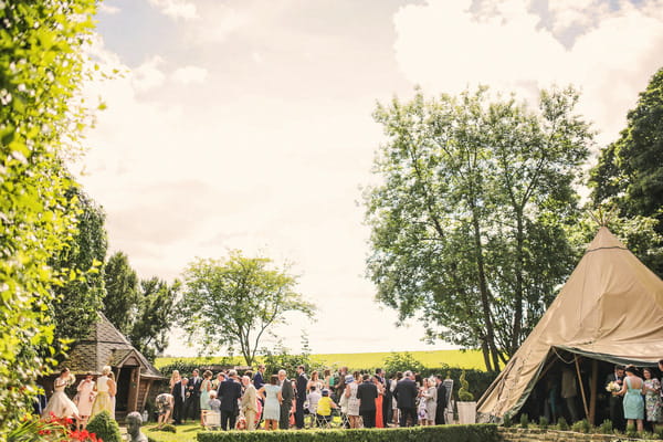 Wedding guests in grounds of Woodhill Hall