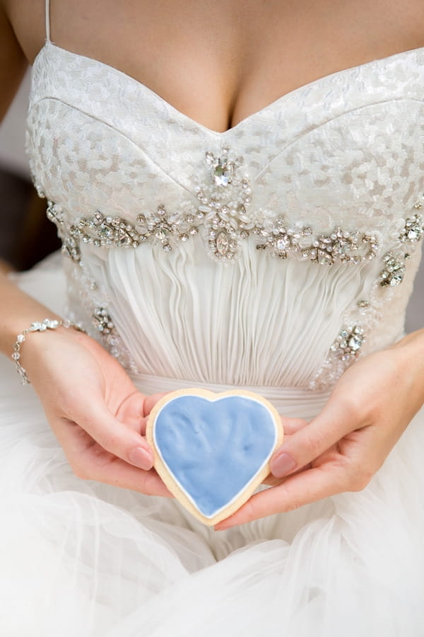 Bride holding heart biscuit