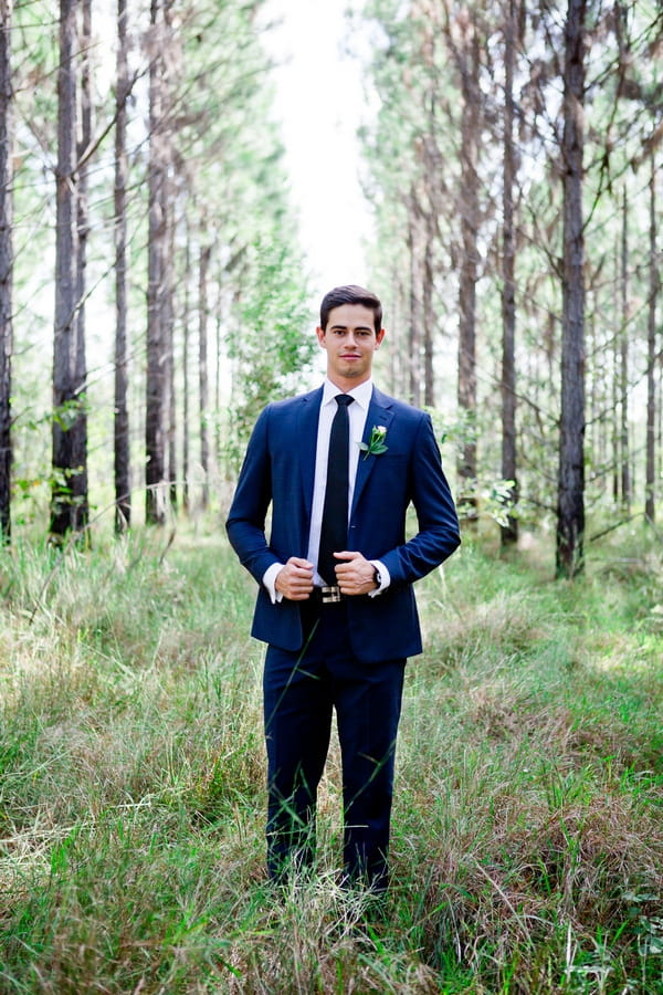 Groom with blue suit in woodland