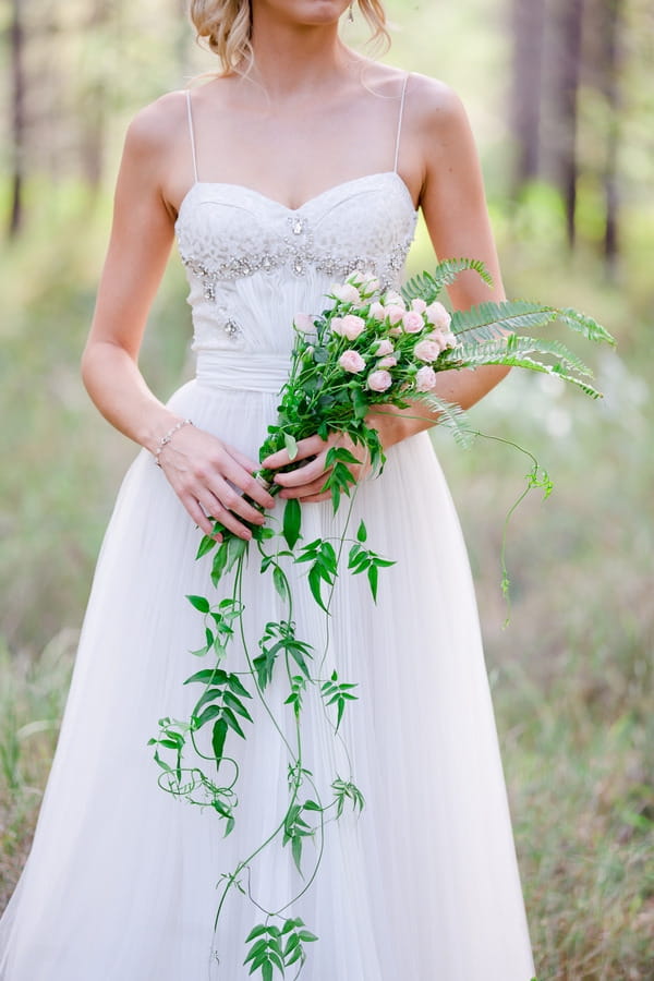 Bride with long trailing foliage bouquet