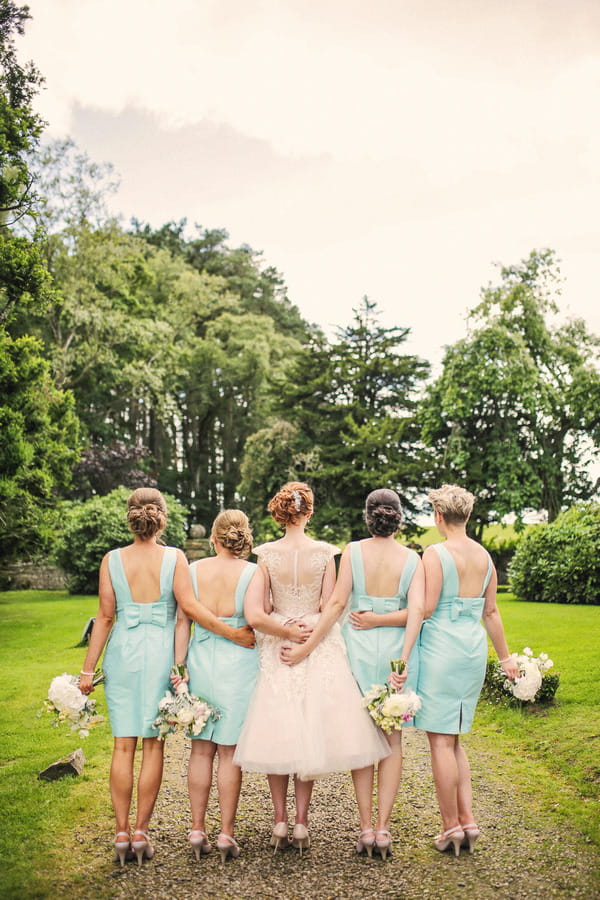 Back of bride with bridesmaids in mint dresses