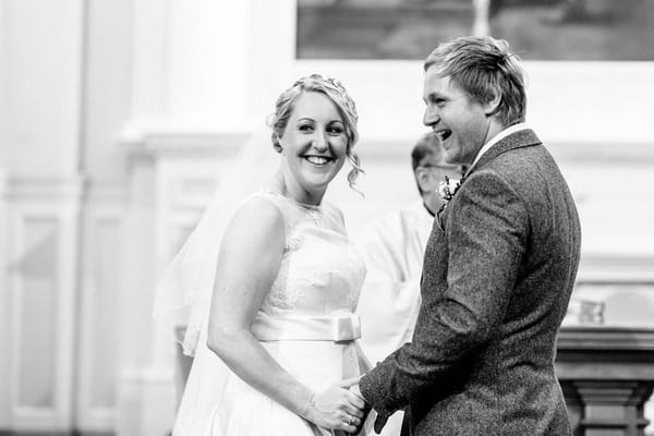 Bride and groom smiling after kiss