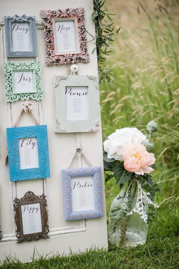 Picture frame wedding seating plan and vase of flowers