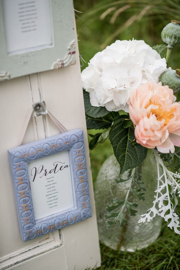 Picture frame on door frame for wedding seating plan