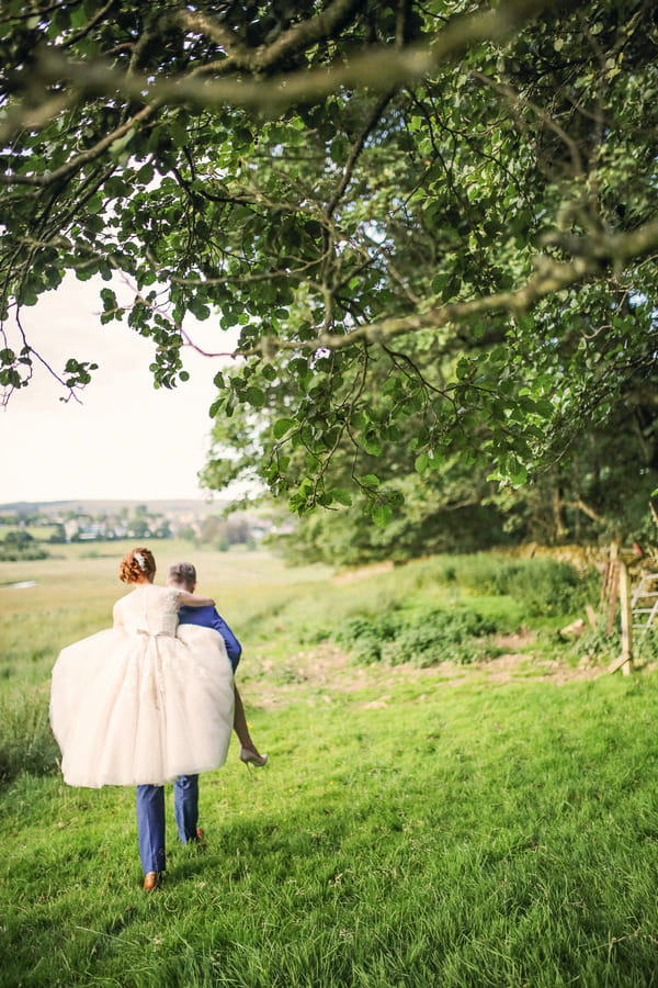 Groom giving bride piggyback