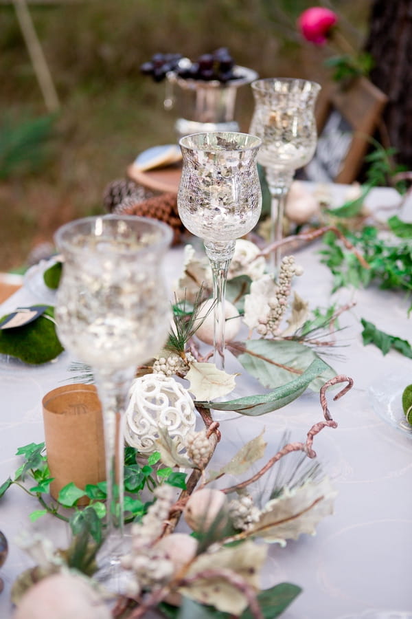 Row of glasses on woodland styled wedding table