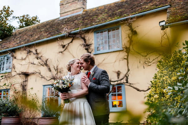 Bride and groom about to kiss outside South Farm, Royston