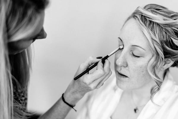 Bride having eye make-up applied