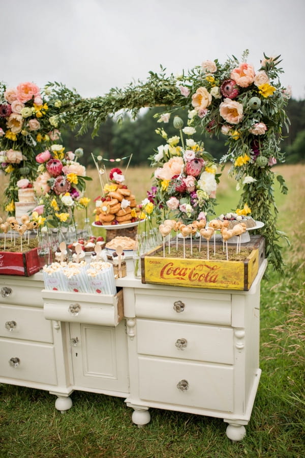 Rustic dresser of wedding cakes and desserts