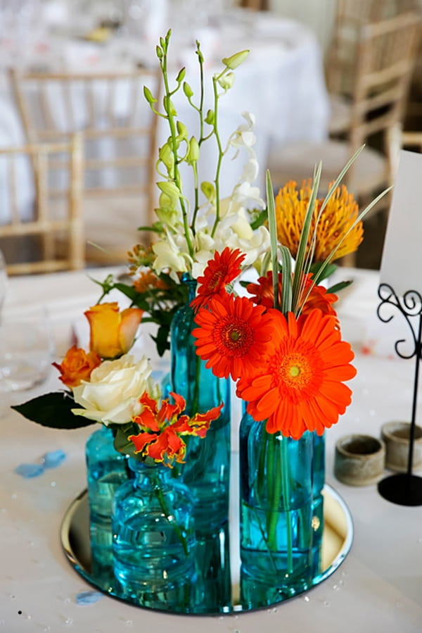 Orange flowers in blue glass vases