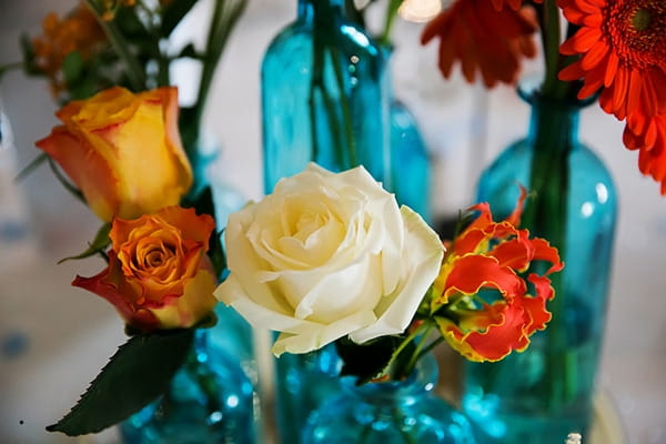 Orange and white flowers in blue vases