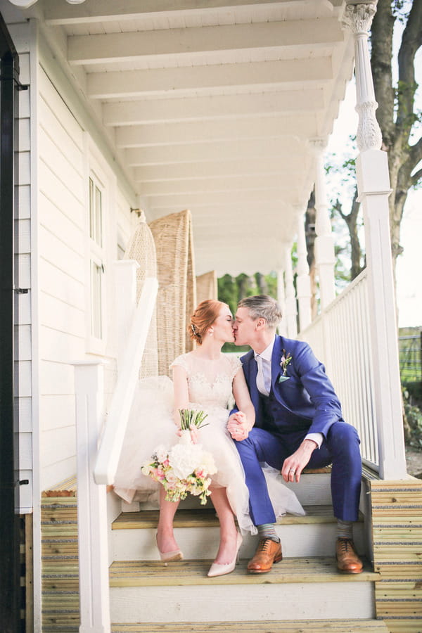 Bride and groom kissing on steps