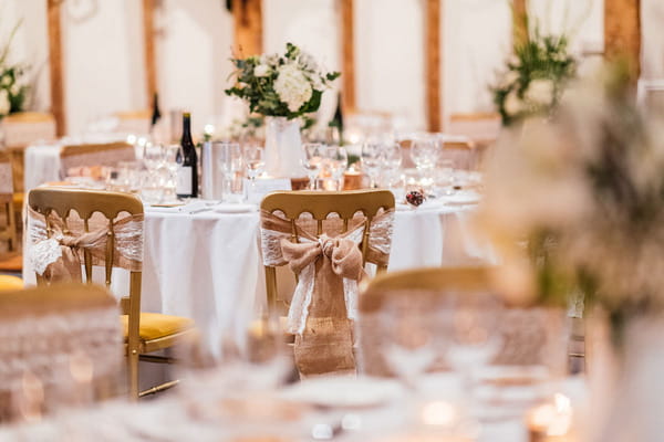 Rustic hessian bow on back of wedding chair