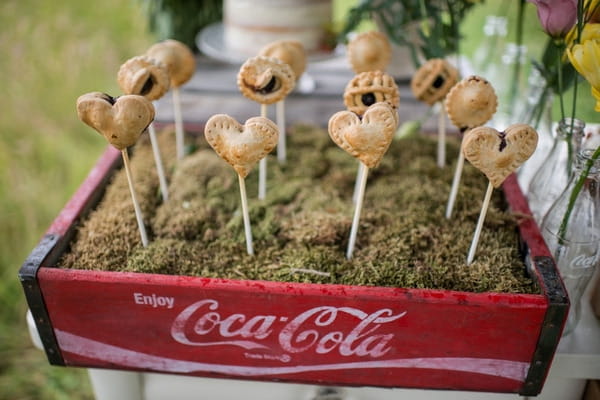 Old red Coca Cola box with pie pops sticking out