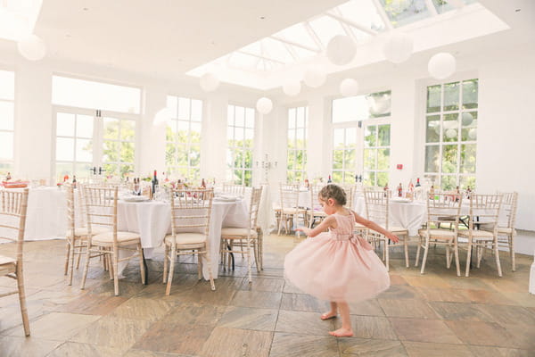 Flower girl by tables at Woodhill Hall