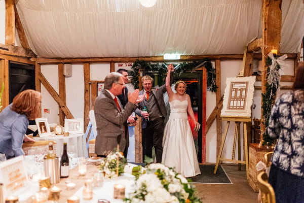 Bride and groom entering wedding reception at South Farm, Royston