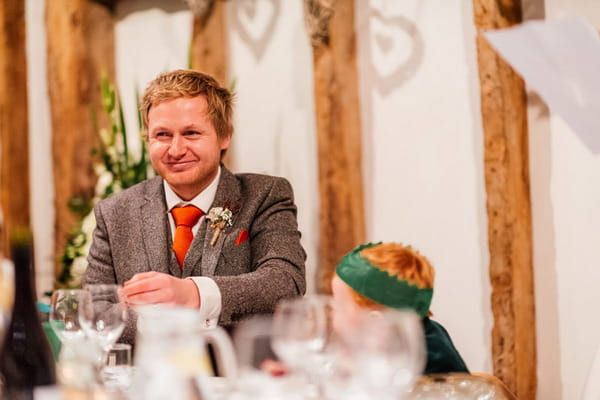 Groom listening to wedding speech