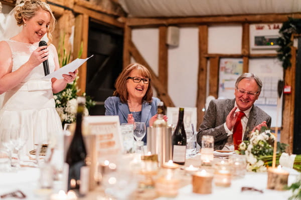 Parents laughing at bride's wedding speech