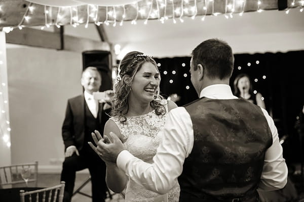 Happy bride and groom on dance floor
