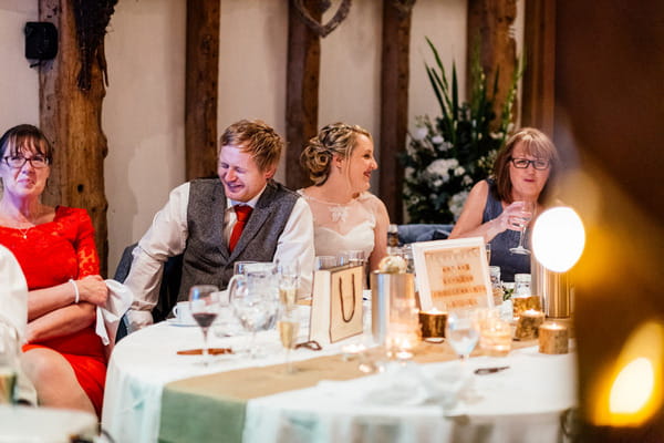 Groom laughing at best man speech