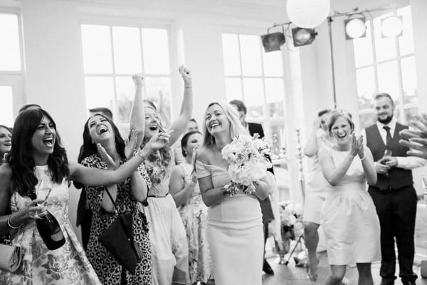 Lady catching bride's bouquet