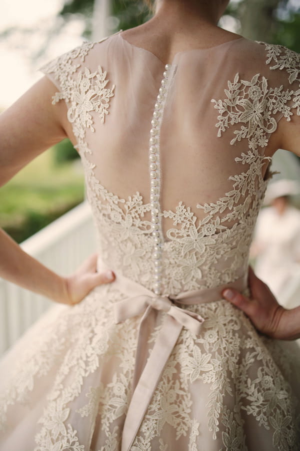 Lace detail on back of bride's House of Mooshki wedding dress