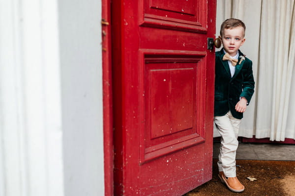 Pageboy standing by red door